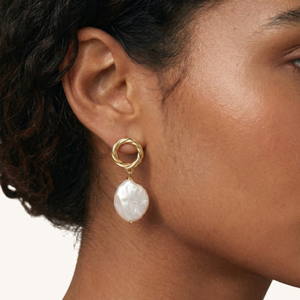 Angled view of Pearl Glow Drop Vermeil Earrings with luminous irregular pearl drops, twisted circular studs and post backs | Olaty