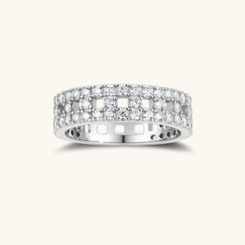 Wide sterling silver ring with three rows of brilliant moissanite stones in geometric pavé setting on white background
