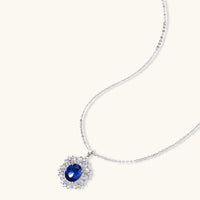 Sapphire blue oval halo pendant necklace with clear zirconia surround | Olaty