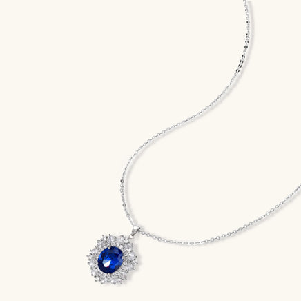 Sapphire blue oval halo pendant necklace with clear zirconia surround | Olaty