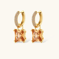 Close-up of square-cut champagne zirconia drop huggie earrings with clear zirconia accents | Olaty