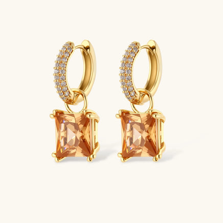 Close-up of square-cut champagne zirconia drop huggie earrings with clear zirconia accents | Olaty