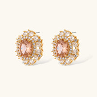 Close-up of vintage peach zirconia halo stud earrings with clear zirconia accents | Olaty