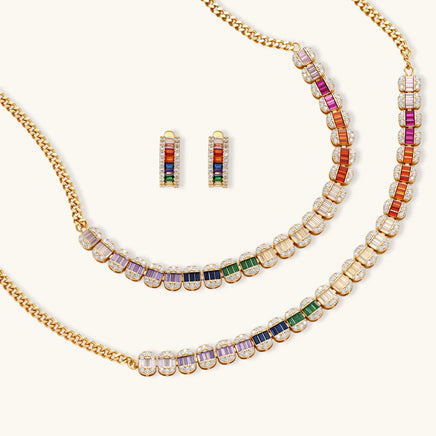 Rainbow baguette zirconia necklace bracelet and matching earrings arranged on a light background | Olaty
