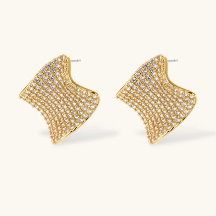 Close-up of curved wave stud earrings covered with clear cubic zirconia | Olaty