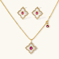 Pink and clear zirconia clover necklace with matching stud earrings on a light background | Olaty