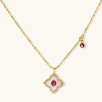 Clover pendant necklace with pink center stone and clear zirconia border on a light background | Olaty