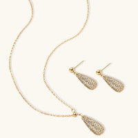 Crystal teardrop necklace and matching earrings arranged on a light background | Olaty