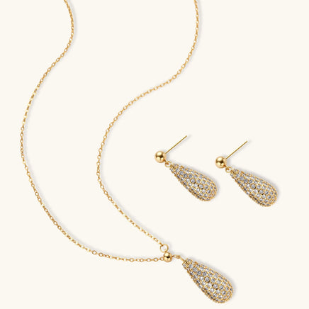 Crystal teardrop necklace and matching earrings arranged on a light background | Olaty