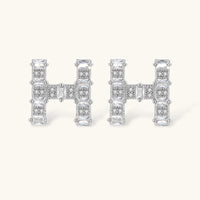 Pair of H initial Zirconia stud earrings with geometric design | Olaty