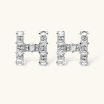 Pair of H initial Zirconia stud earrings with geometric design | Olaty