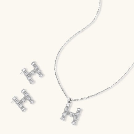 H initial Zirconia necklace and matching stud earrings arranged together | Olaty