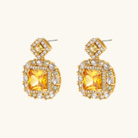 Close-up of golden square Zirconia statement drop earrings with clear stone halo | Olaty