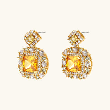 Close-up of golden square Zirconia statement drop earrings with clear stone halo | Olaty