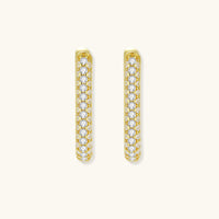 Front view of slim gold huggie earrings covered with sparkling pavé crystals | Olaty