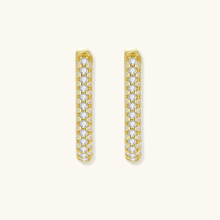 Front view of slim gold huggie earrings covered with sparkling pavé crystals | Olaty