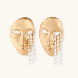 Gold sculptural face statement earrings with cascading chain fringe and abstract facial details | Olaty