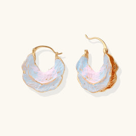 Iridescent blue and pink shell hoop earrings with sculptural gold-tone edges and hinged closures | Olaty