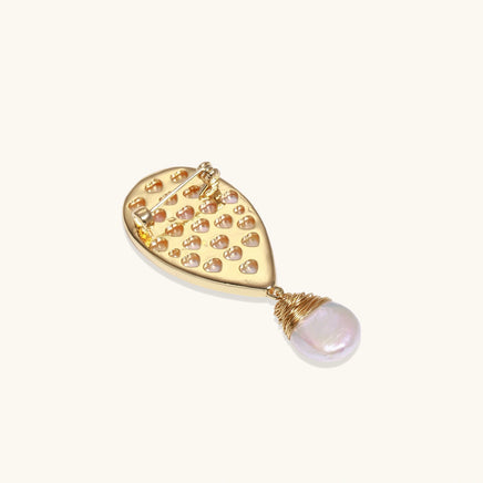 Back view of shell bird brooch showing gold pin fastening and suspended baroque pearl | Olaty