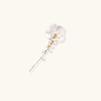 Angled view of Pearl Cascade Pansy Brooch with carved shell petals, pearl cascade and gold-tone chain | Olaty