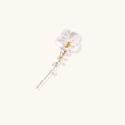 Angled view of Pearl Cascade Pansy Brooch with carved shell petals, pearl cascade and gold-tone chain | Olaty