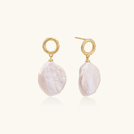 Pearl Glow Drop Vermeil Earrings worn on ear with lustrous irregular pearl drop and sculptural twisted circular stud | Olaty