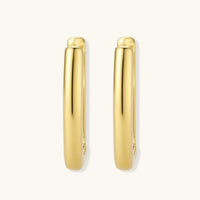 Polished gold-plated sterling silver hoop earrings with hinged closure mechanism on white background.