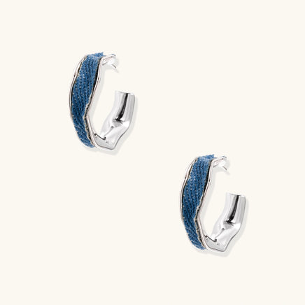 Pair of blue denim hoop earrings with angular sculpted silver-tone frames | Olaty