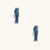 Side view of denim fabric hoop earrings showing textured blue inlay and polished metal edges | Olaty