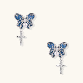 Royal blue denim butterfly drop earrings with silver-tone sculptural wings, pearl centers and dangling cross charms | Olaty
