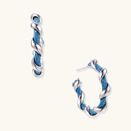 Denim twist hoop earrings with blue denim fabric wrapped in polished silver-tone sculptural spirals | Olaty
