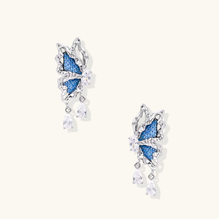 Blue denim sculptural butterfly drop earrings with silver-tone wings and sparkling zirconia drops | Olaty