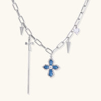 Silver-tone chain necklace with blue denim cross pendant, zirconia center and spike charms | Olaty