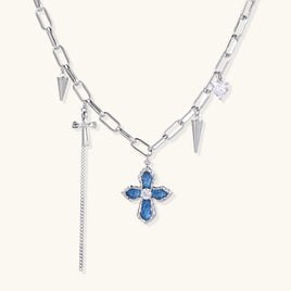 Silver-tone chain necklace with blue denim cross pendant, zirconia center and spike charms | Olaty