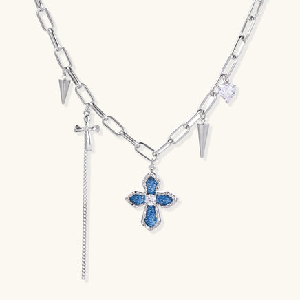 Silver-tone chain necklace with blue denim cross pendant, zirconia center and spike charms | Olaty