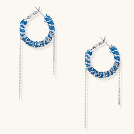 Front view of blue denim fabric hoop earrings with wrapped silver-tone chains and twin dangling chain details | Olaty