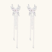 Celestial Phoenix pearl cascade statement earrings with sculptural wings and flowing chains front view | Olaty