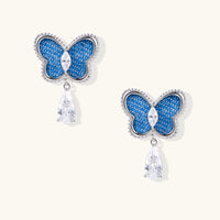 Electric blue denim butterfly drop earrings with silver-tone frames and sparkling clear zirconia teardrop pendants | Olaty