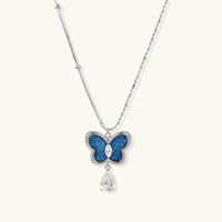 Blue denim butterfly pendant necklace with zirconia center and dangling teardrop stone | Olaty