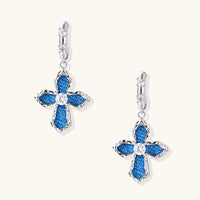Front view of blue denim cross drop earrings with sparkling round zirconia accents | Olaty
