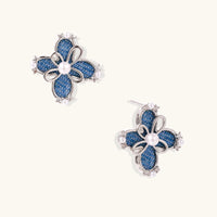 Blue denim flower stud earrings with pearl centers, zirconia accents and sculptural silver-tone details | Olaty