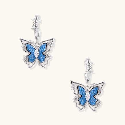 Blue denim butterfly drop earrings with zirconia centers and sculptural barbed wire inspired hoops | Olaty
