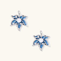 Blue denim floral stud earrings with pearl centers, zirconia accents and sculptural silver-tone petals | Olaty