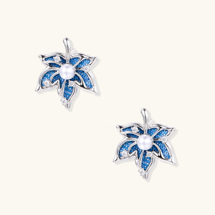 Blue denim floral stud earrings with pearl centers, zirconia accents and sculptural silver-tone petals | Olaty