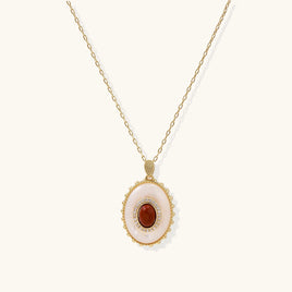 Front view of oval amber cameo pendant necklace with mother-of-pearl surround and sparkling stone accents | Olaty