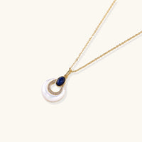 Angled view of blue lapis lazuli and mother of pearl pendant necklace with crystal accents | Olaty