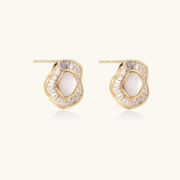 Gold-plated stud earrings with central freshwater pearl surrounded by radiating baguette crystals in sunburst design