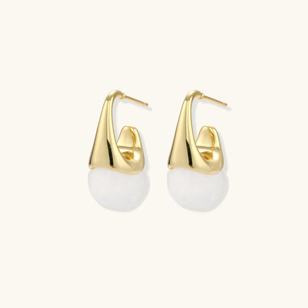 Sculptural cone hoop earrings with white resin drops shown at an angled side view | Olaty
