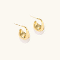 Sculptural cone hoop earrings with polished gold curves, white resin drops and visible posts | Olaty