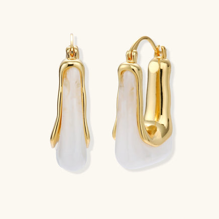 Liquid curve white resin hoop earrings with sculptural gold-tone frames, front and side view | Olaty